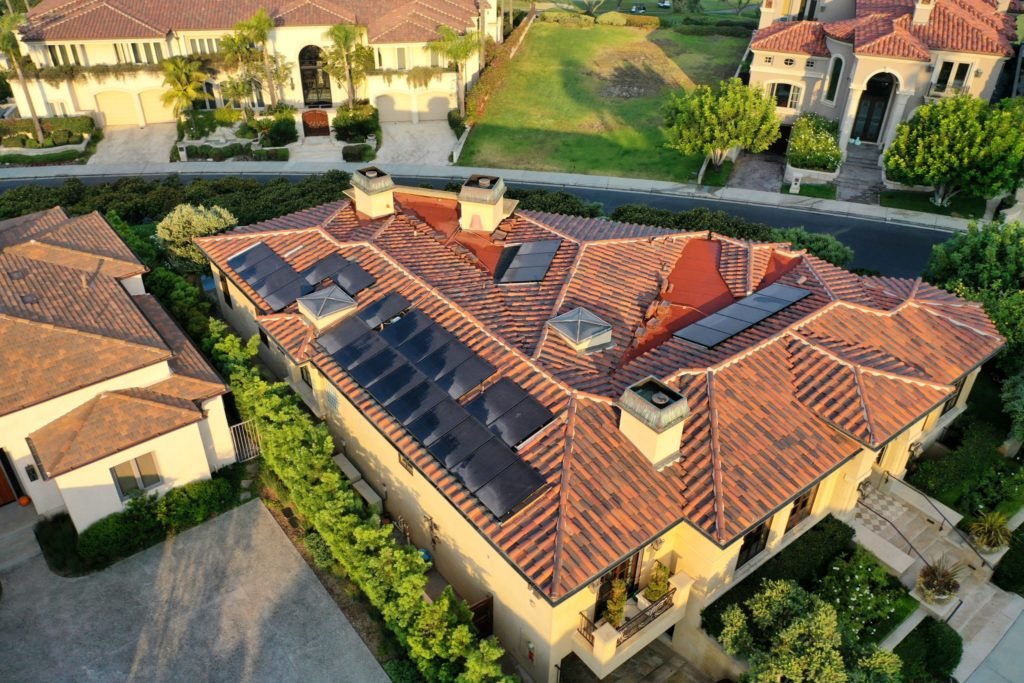 black solar panels on red roof in laguna beach ca